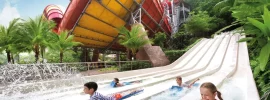 Kids racing down water slides at Sunway Lagoon Theme Park
