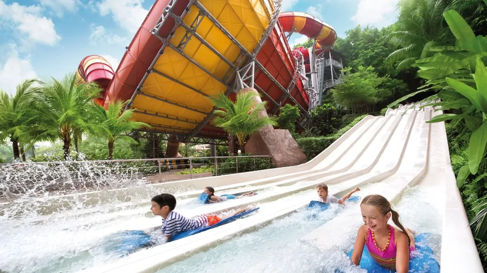 Kids racing down water slides at Sunway Lagoon Theme Park